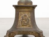 an antique bronze candle holder with a statue of a woman holding a child