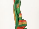 sculpture of a green and red bird on a white base