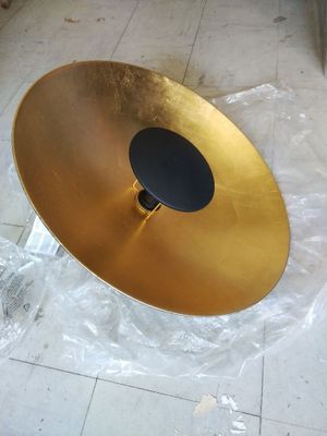 a gold plate with a black disc on top of it