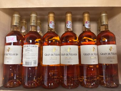 several bottles of wine are lined up on a shelf