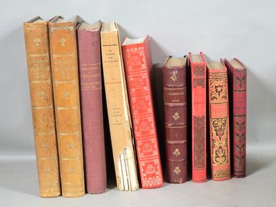 several old books are lined up on a white surface