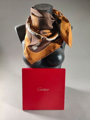 brown silk scarf on a mannequin head with a red box