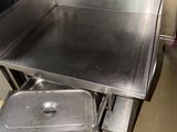 a stainless steel counter top with a metal pan in it