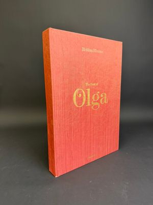 un livre rouge orné de lettres dorées, posé sur une table