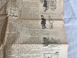 newspapers are laying on a bed with a white sheet of paper