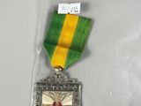 a small medal in a plastic bag on a table
