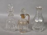 three glass decanters sitting next to each other on a table