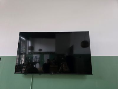 a flat screen tv mounted on the wall in the living room