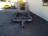a trailer that is parked in front of a building