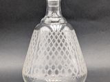 an old fashioned glass decanter with a glass stopper on top