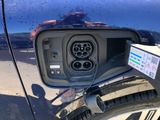 a close up of a car ' s rear view mirror with an electric charger attached to it