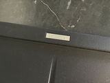 a black laptop computer sitting on top of a black table