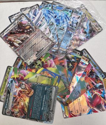 a pile of pokemon cards sitting on top of a table