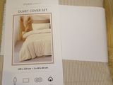 two sheets of bedding on a wooden floor next to each other