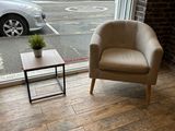 a chair and a table in a room with a view of the street