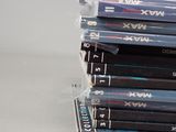many dvds stacked on top of each other on a table