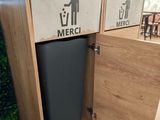 two trash cans that are sitting in a wooden cabinet