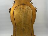 an antique wooden clock with a bird on top of it