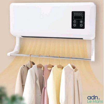 an air conditioner mounted on a wall with clothes hanging on it