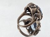 a silver ring with a blue topaz stone in it