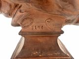 bronze bust of a man on a pedestal with a white background