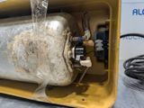 an image of a water heater with a hose attached to it