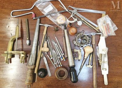 many different tools that are on a wooden table