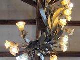 a chandelier that has a bunch of flowers on it
