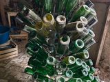 bottles are stacked on a wire rack in a room