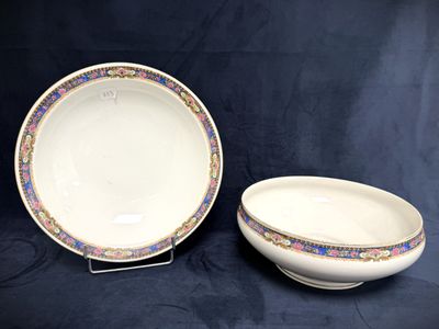a white bowl and saucer sitting on top of a table