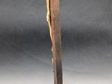 wooden crucift with a cross on a pedestal on a gray background