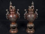 pair of antique bronze vases with dragon handles on stands