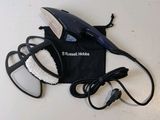a black hair dryer and a pair of shoes on a table