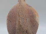 a brown vase that is sitting on a table