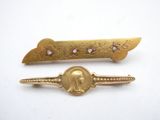 pair of gold tone hair clips with a picture of a woman on it