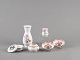 a group of small vases and bowls on a table