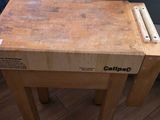a wooden table with a laptop on top of it