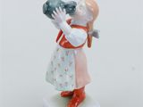 porcelain figurine of a girl holding a bottle of water