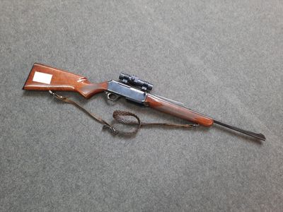 the rifle is laying on the floor next to the gun
