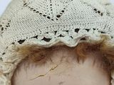 a close up of a mannequin head with a hat on