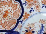 a close up of a plate with a flower design on it