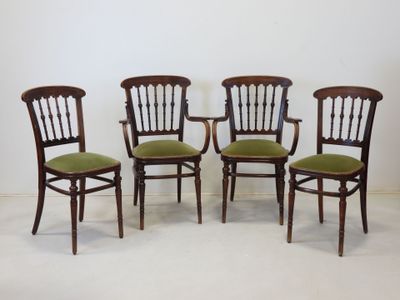 three chairs with green cushions and a white wall in the background