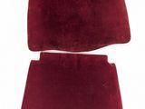 a close up of a pair of red carpeted seats on a white surface