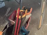 a bucket full of tools on the floor next to a table