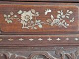 a close up of a wooden box with flowers on it