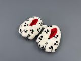 pair of dalmatian slippers with red bow on them