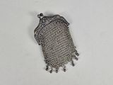 an old silver chainmail purse with a chain hanging from it