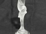 a glass vase with a design on it on a black background