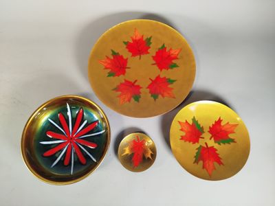 yellow and red plates and bowls with maple leaves on them