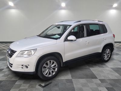 the white volkswagen suv is parked on a checkered tile floor